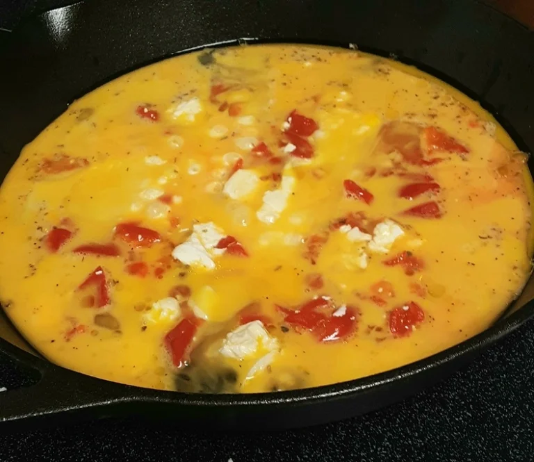 Italian Frittata with Roasted Red Peppers and Mozzarella Cooking in Skillet